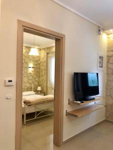 a room with a television and a room with a bedroom at Thalassa in Siviri