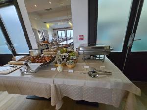 a table with a buffet of food on it at Hôtel La Riviera Victoria in Yvoire