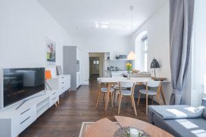 a living room with a table and a dining room at Alte Schule Reichenau an der Rax in Reichenau