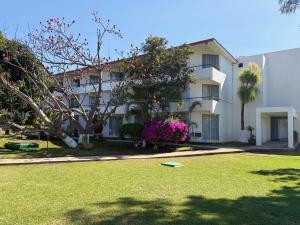 a building with a yard with a frisbee in the grass at Hotel San Felipe in Oaxaca City