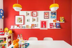 a dining room with red walls and a white table at Henry's House Parma in Parma