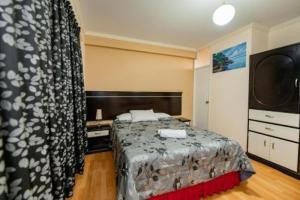a hotel room with a bed and a television at Eras Hotel in Chiclayo