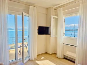 a room with a balcony with a view of the ocean at Sea Sparkle 1a in Preveza