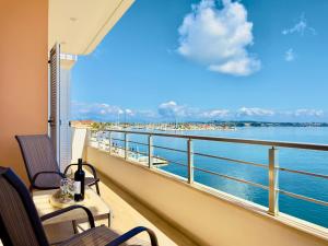 a balcony with chairs and a view of the ocean at Sea Sparkle 1a in Preveza