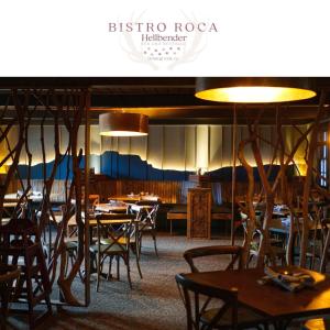 a dining room with tables and chairs and lights at Hellbender Bed & Beverage in Blowing Rock