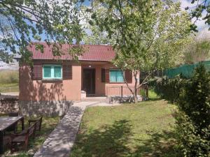 a small house with a red roof at Seoski raj in Podgorica +3 photos