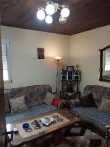 a living room with two couches and a coffee table at Seoski raj in Podgorica