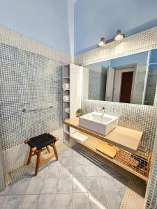 a bathroom with a sink and a mirror at Arion Syros Luxury Rooms and Suites in Ermoupoli +102 photos