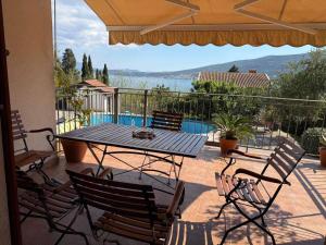 a patio with a table and chairs and a pool at Mio Lux in Baošići