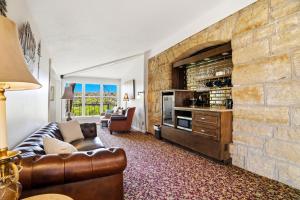 a living room with a couch and a stone wall at St. Croix Valley Inn in Shafer