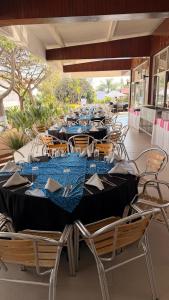 a long table with blue tables and chairs at Hotel San Felipe in Oaxaca City