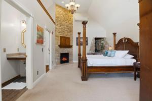 a bedroom with a bed and a fireplace at St. Croix Valley Inn in Shafer