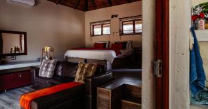 a bedroom with a bed and a couch and a bed at Mabalingwe Nature Reserve - Elephant Lodge - Tjaila in Warmbaths +61 photos