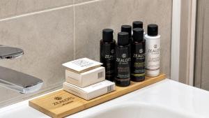 a bathroom sink with a shelf with products on it at Seafront Luxury Apartment in Kalamata +31 photos