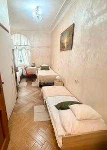 a room with two beds and a chair in it at IDEAL in Płock