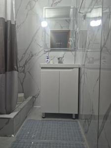 a bathroom with a sink and a mirror at Stay Osh in Osh +15 photos