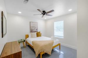 a bedroom with a bed and a ceiling fan at Peaceful Horizons at The Heron's Rest in Biloxi