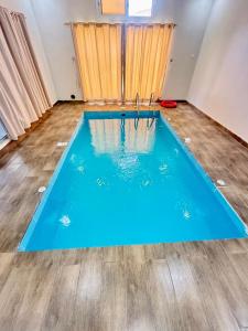 a large blue swimming pool in a room at Chalets Zara شاليهات زارا in Taif