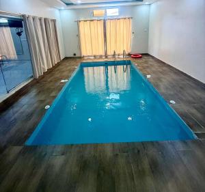 a large blue swimming pool in a room at Chalets Zara شاليهات زارا in Taif +6 photos