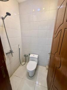 a small bathroom with a toilet and a shower at Chalets Zara شاليهات زارا in Taif