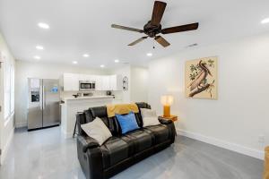 a living room with a couch and a ceiling fan at Peaceful Horizons at The Heron's Rest in Biloxi