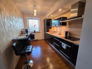a kitchen with a counter and a chair in a room at Silent Apartment Płock in Płock
