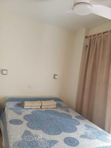 a bedroom with a bed with a blue rug at Casa Yuni in Candelaria