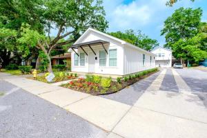 a small white house with a driveway at Peaceful Horizons at The Heron's Rest in Biloxi