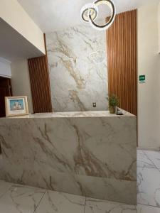 a marble counter in a bathroom with a chandelier at Hotel Casa Victoria in Tequila