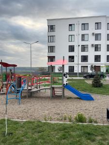 a park with a playground with a slide and a slideintend at Inamstro Home in Orhei