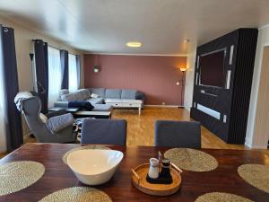 a living room with a table and a couch at T&T Vardø in Vardø