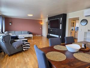 a living room with a table and a couch at T&T Vardø in Vardø +13 photos