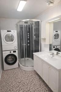 a bathroom with a washing machine and a sink at T&T Vardø in Vardø