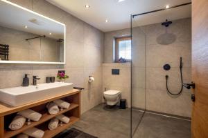 a bathroom with a sink and a shower at Apart Oberau - new from 2026 in Hippach