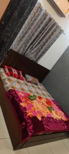 a bed with a colorful blanket and pillows on it at OM DAYAMA Please in Khātu +16 photos