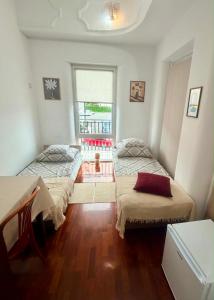 a room with two beds and a window and a table at IDEAL in Płock +14 photos