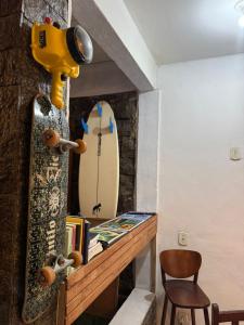 a skateboard sitting on a shelf next to a table at Bouganvile Hostel Ilha Grande in Abraão