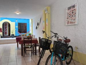two bikes parked in a restaurant with a table and chairs at Wayra Hostel Huanchaco in Huanchaco