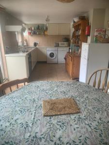 a kitchen with a table with a plate on it at Spacious Suffolk Cottage in Village Setting in Westleton +8 photos