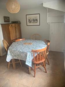 a dining room table with chairs and a table and a table and chairsktop at Spacious Suffolk Cottage in Village Setting in Westleton