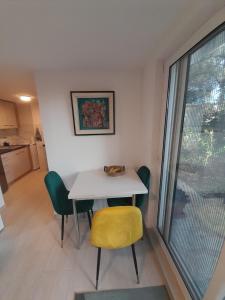 a table and chairs in a room with a window at Apart SRDJ&MAR in Dobra Voda