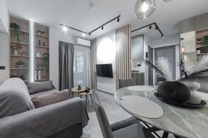 a living room with a table and a couch at Friendly Backyard in Thessaloniki