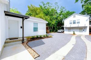 a house with a white garage and a driveway at Hopkins 144 in Biloxi