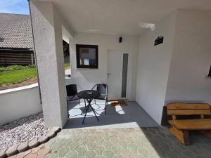 a room with a table and a chair on a patio at Cosy Studio CatHouse in Radovljica