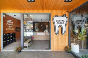 an entrance to a dental clinic with a sign on the door at Dent Station Residence in Ban Suan +51 photos