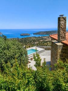 a villa with a swimming pool and the ocean at Aurora Spinalonga Garden Villa with Jacuzzi Pool in Chavgas