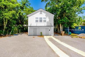 a white house with a garage in a driveway at Hopkins 144 in Biloxi +1 photo