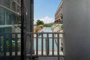 a view of a pool from a balcony at Dent Station Residence in Ban Suan