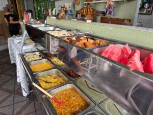 a buffet line with many different types of food at Pousada O Leão in Piaçabuçu