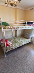 two bunk beds in a room with a chandelier at lits superposé in Marseille